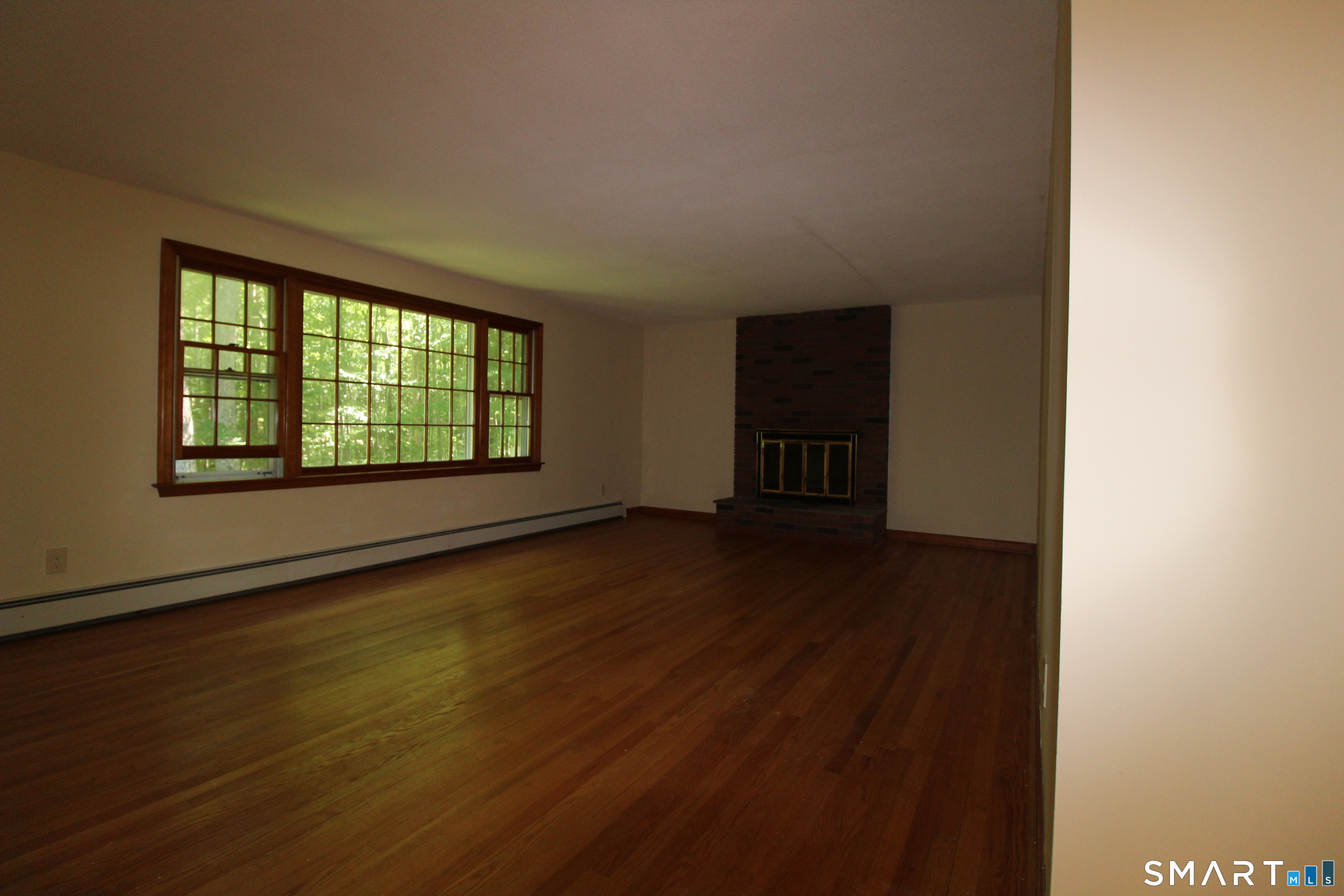 67 Mulberry Road Mansfield, CT 06250 - Photo 19 of 27 Lots of natural light and a fireplace.