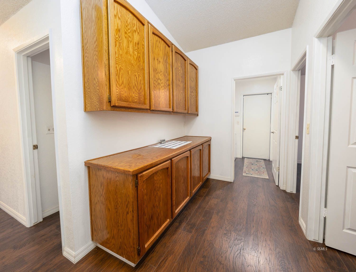 800 Valarie Street Ridgecrest, CA 93555 - Photo 26 of 39 a kitchen with stainless steel appliances granite countertop wooden cabinets and a wooden floor