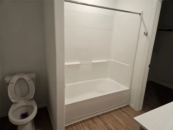 a bathroom with a bathtub and a toilet