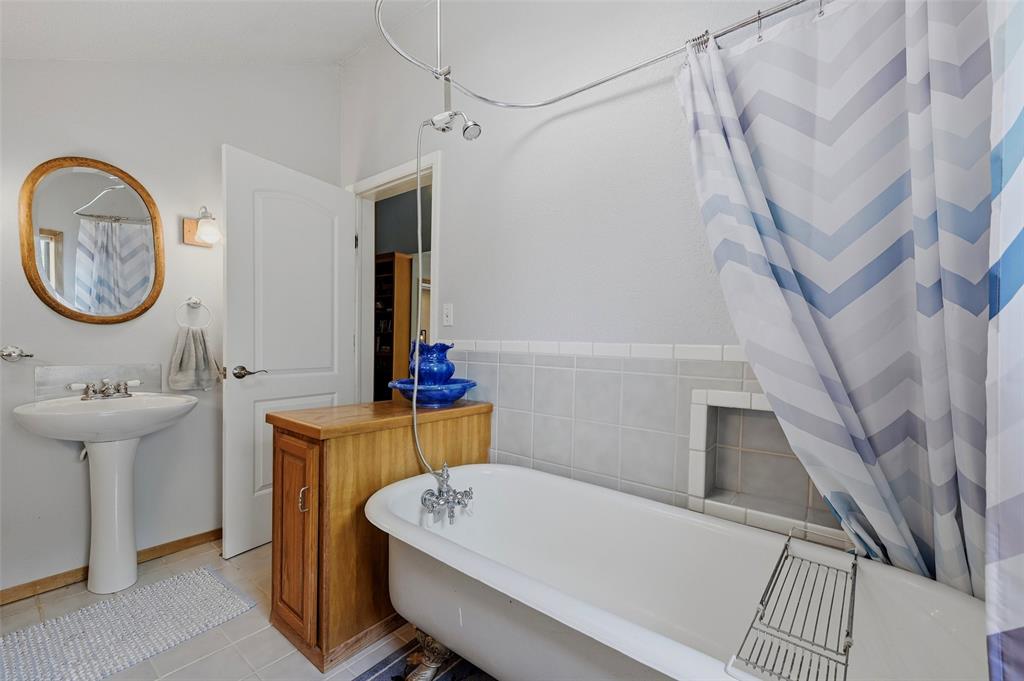 522 High Country Road Sherman, TX 75092 - Photo 23 of 38 a bathroom with a sink a mirror and a shower
