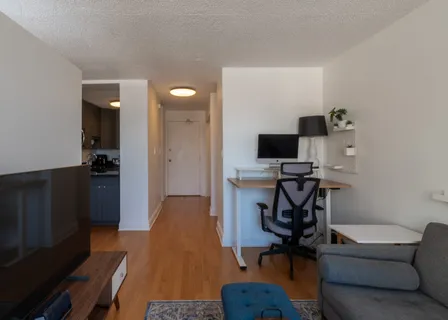 a view of a workspace with furniture and wooden floor