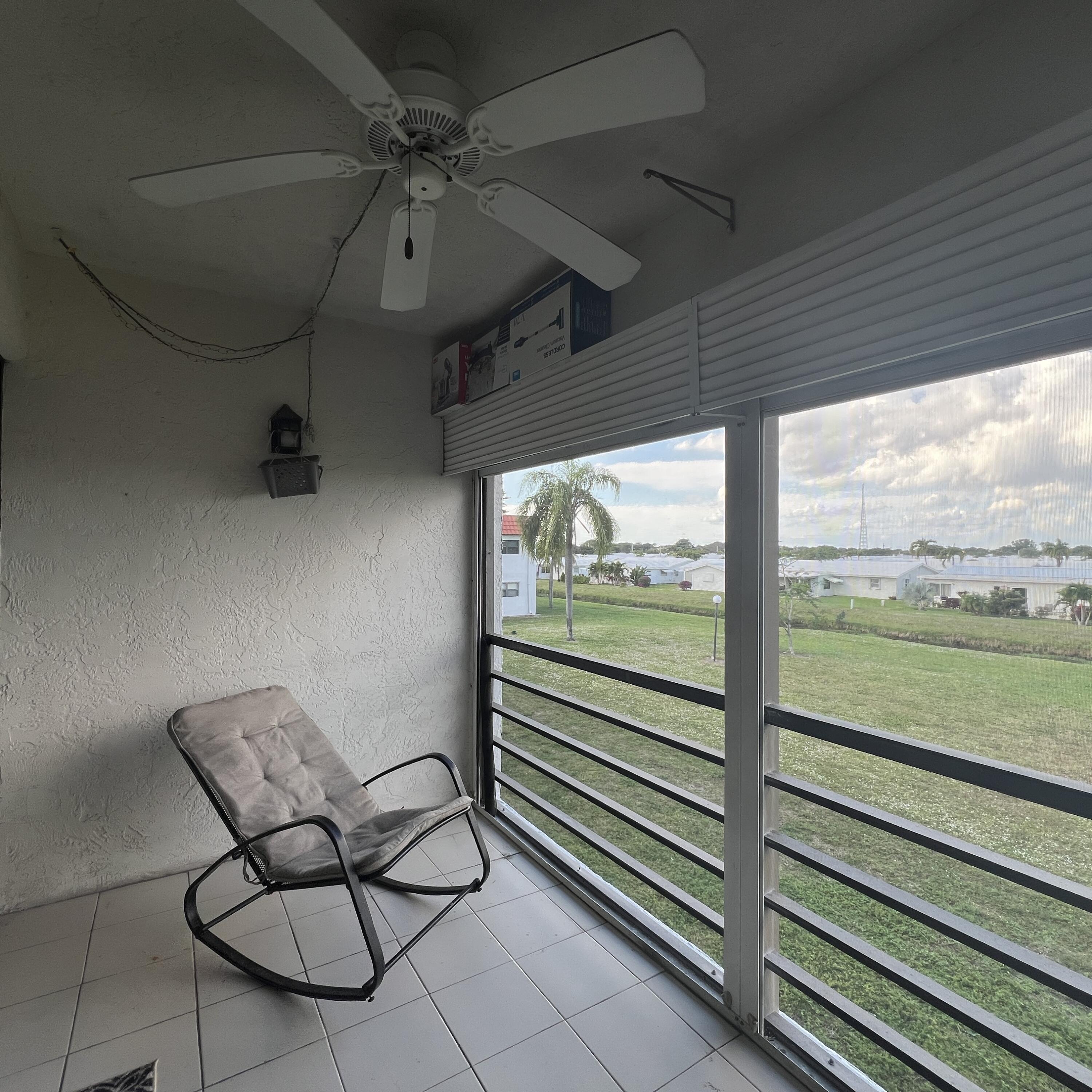 2141 Woolbright Road, Unit L204 Boynton Beach, FL 33426 - Photo 14 of 18 a view of a room with furniture and a ceiling fan