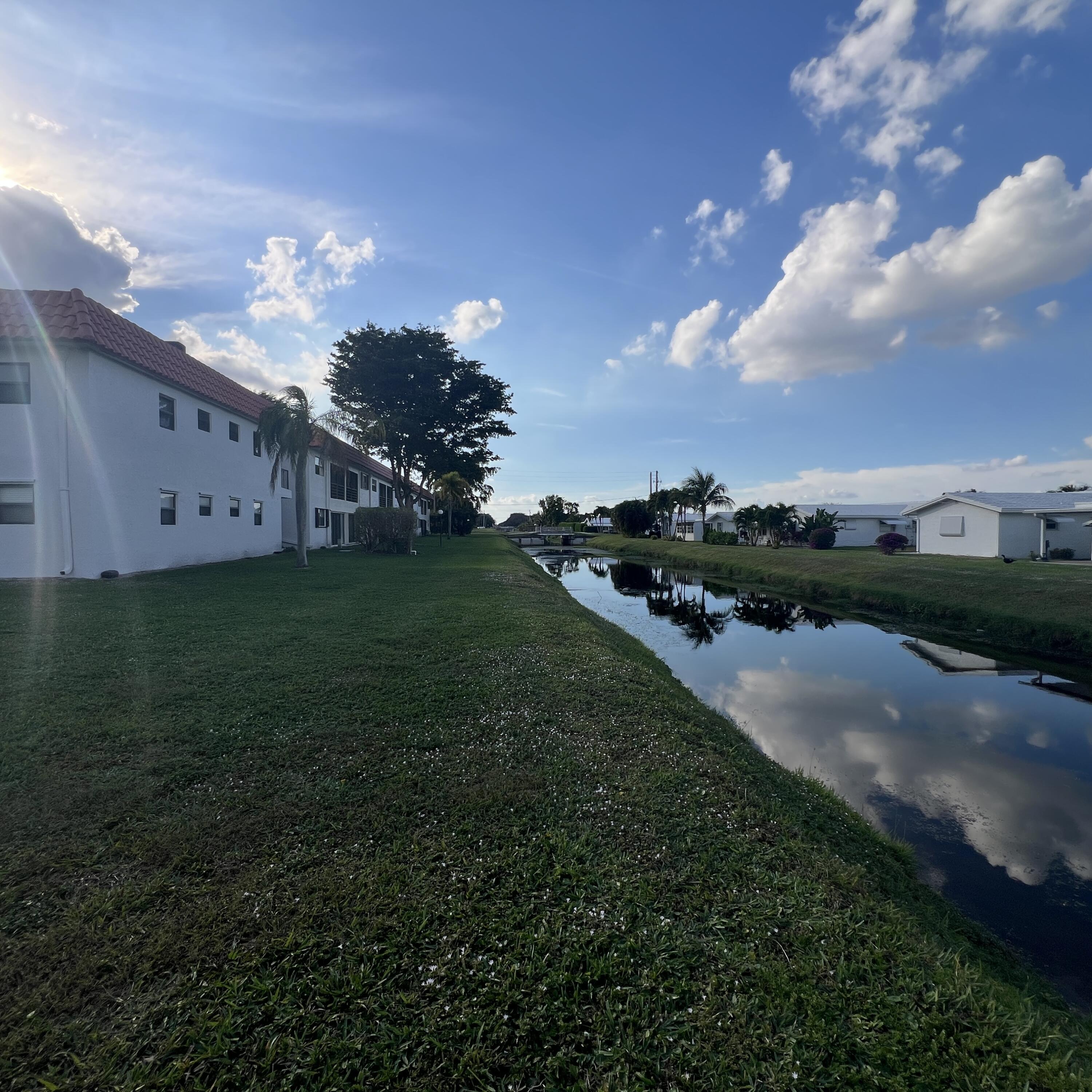 2141 Woolbright Road, Unit L204 Boynton Beach, FL 33426 - Photo 16 of 18 a view of a big yard with an tree and a yard