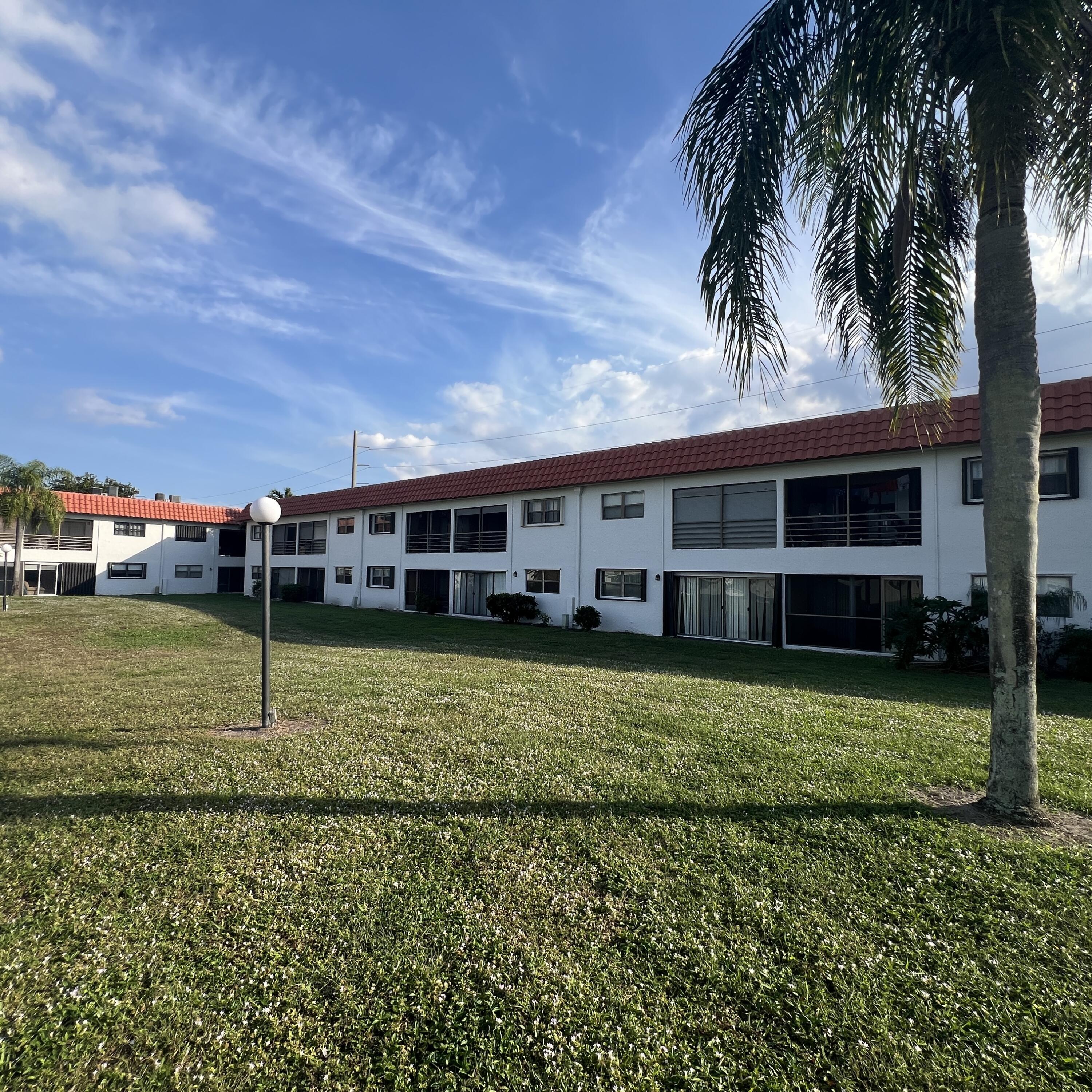 2141 Woolbright Road, Unit L204 Boynton Beach, FL 33426 - Photo 17 of 18 a view of a house with a backyard