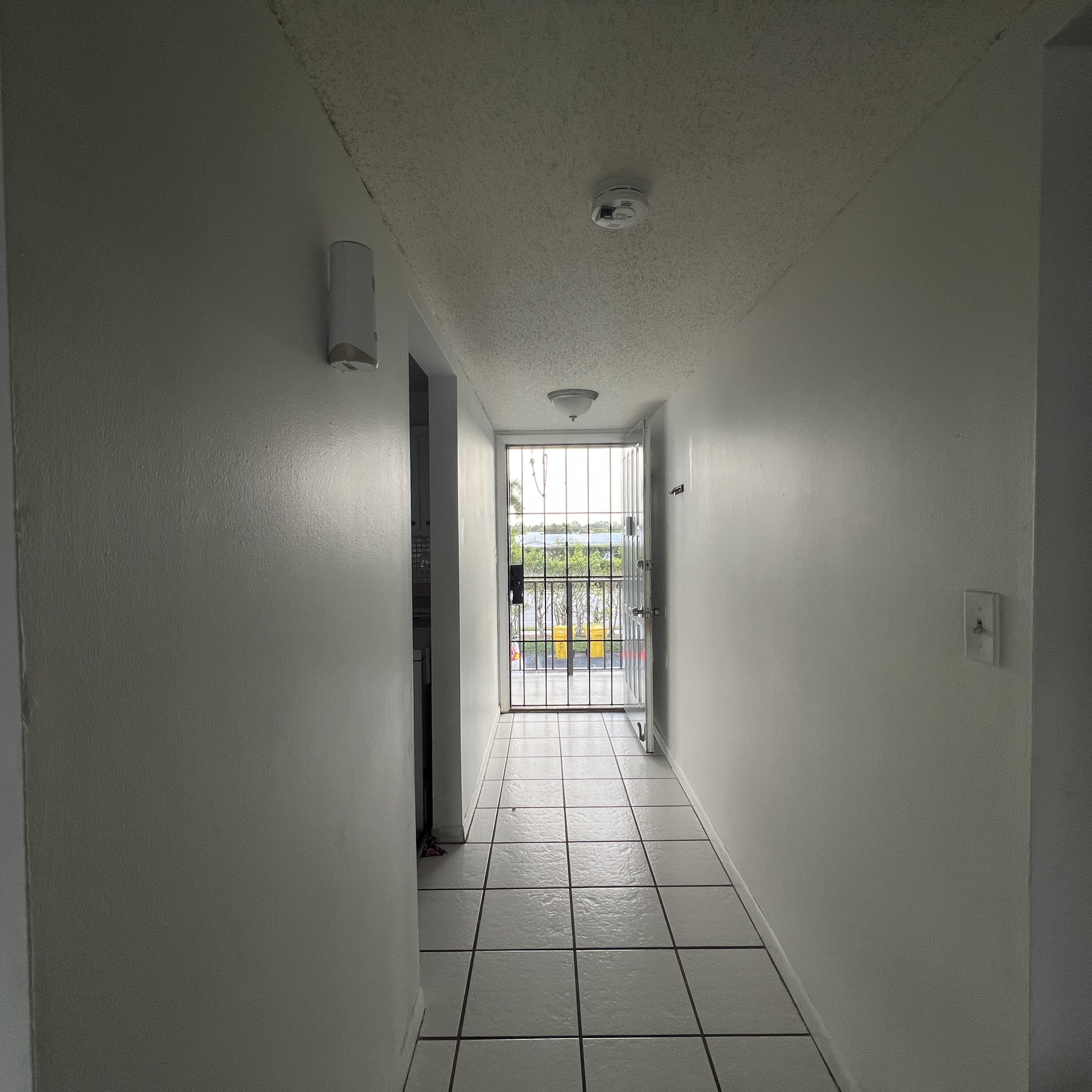 2141 Woolbright Road, Unit L204 Boynton Beach, FL 33426 - Photo 4 of 18 a view of an empty room and window