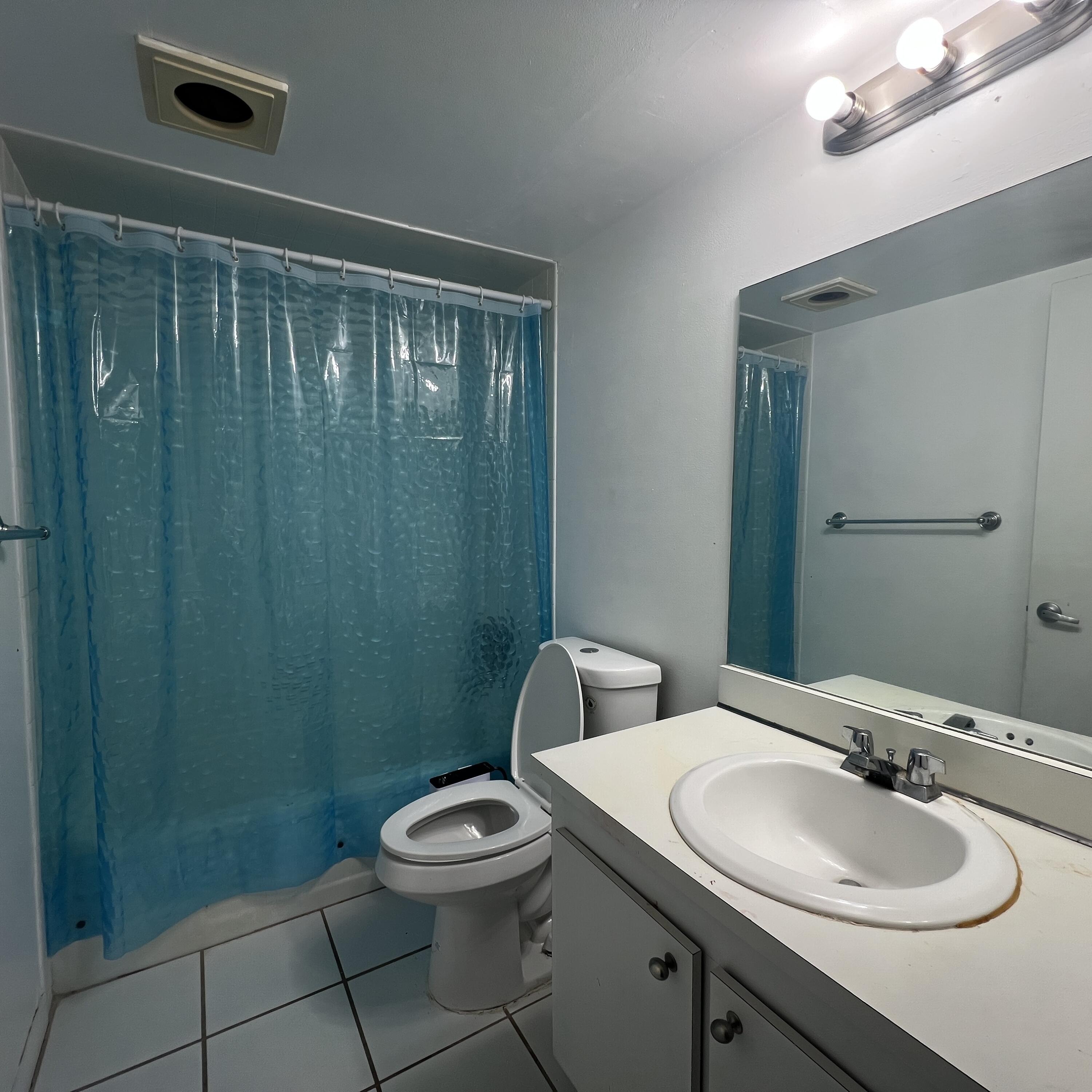 2141 Woolbright Road, Unit L204 Boynton Beach, FL 33426 - Photo 10 of 18 a bathroom with a toilet a sink and mirror