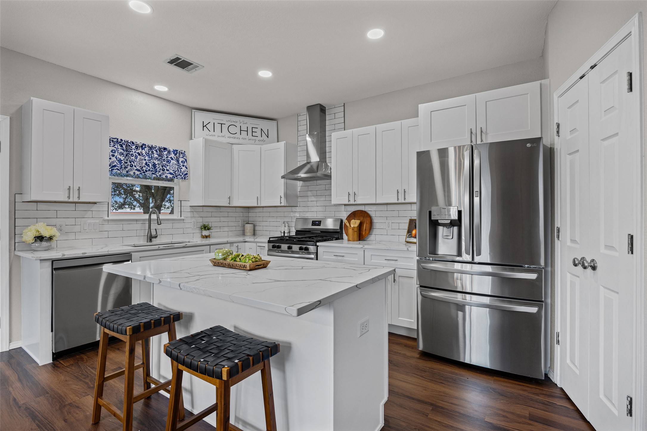 1524 Lochaline Loop Pflugerville, TX 78660 - Photo 2 of 22 Culinary dreams come alive in this well-appointed kitchen featuring a substantial island and pristine white cabinetry.