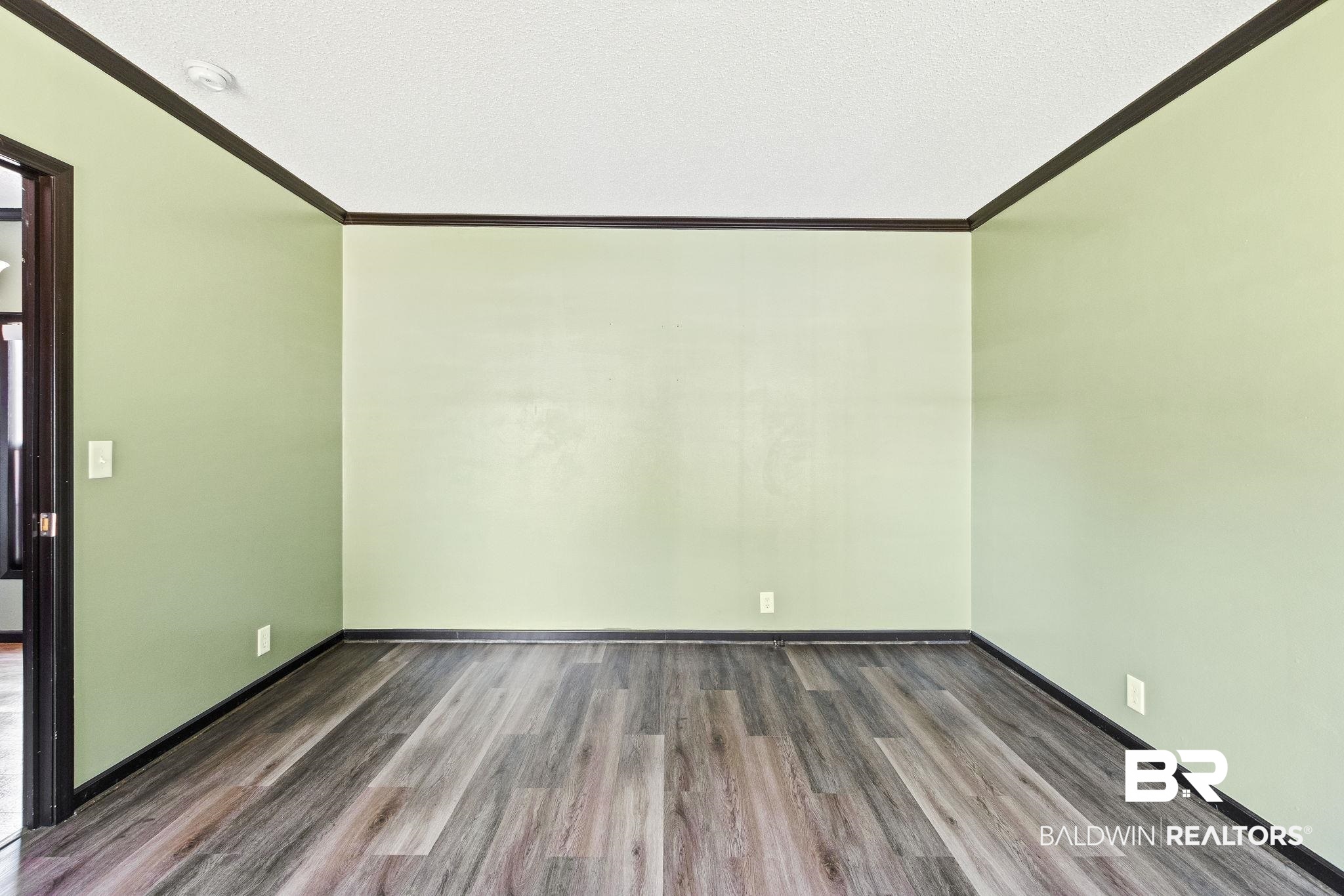 6870 Cecilia Court Theodore, AL 36582 - Photo 33 of 83 Empty room with wood-type flooring, a textured ceiling, and ornamental molding