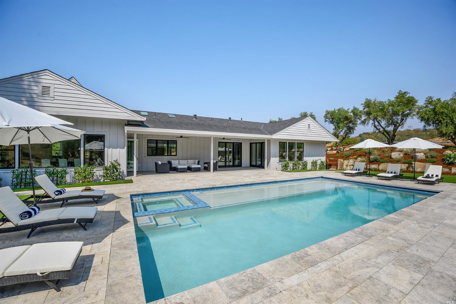a view of house with swimming pool outdoor seating
