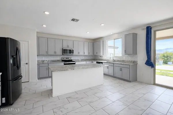 a kitchen with cabinets stainless steel appliances and window