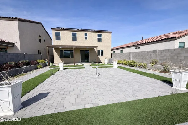 a view of a house with swimming pool and a yard