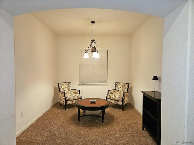a living room with furniture a window and a ceiling fan