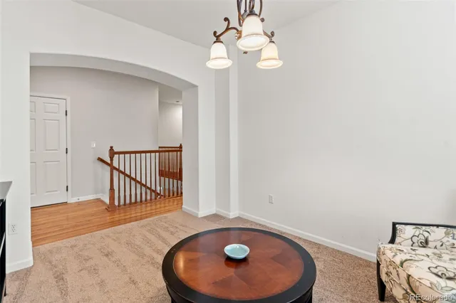 a living room with furniture and a chandelier
