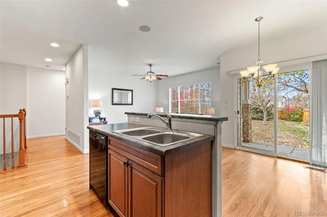 a kitchen with stainless steel appliances granite countertop a refrigerator stove top oven a sink and dishwasher