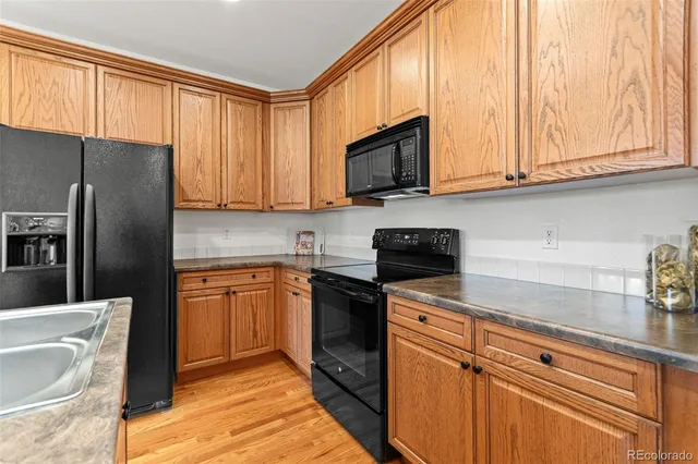 a kitchen with stainless steel appliances granite countertop a refrigerator a sink and dishwasher