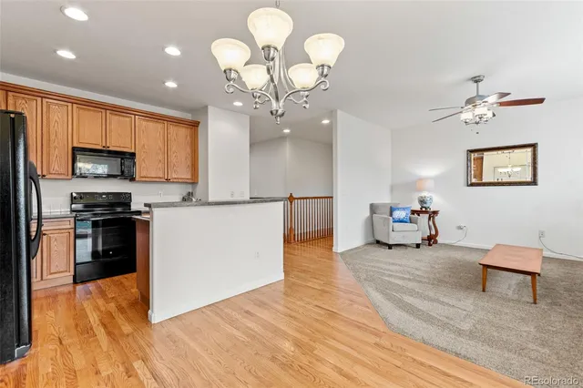 a kitchen with refrigerator cabinets and wooden floor
