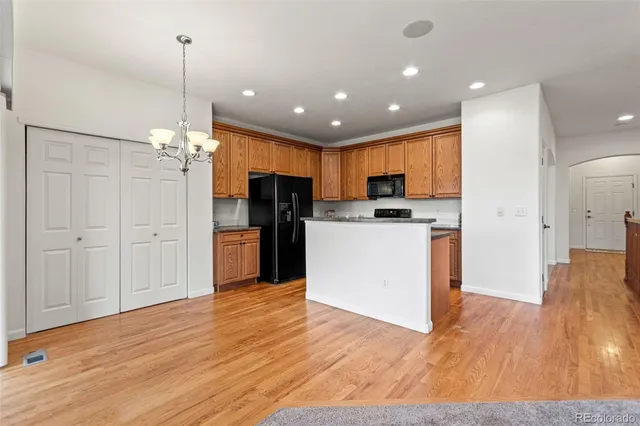 a living room with furniture and kitchen view