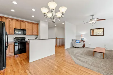 a large bedroom with wooden floor and furniture