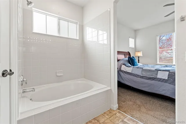 a large bedroom with wooden floor and furniture