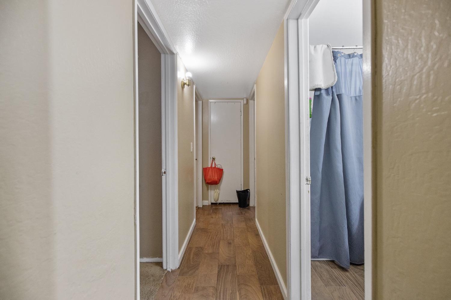 709 Ashlan Way Madera, CA 93638 - Photo 18 of 23 a view of a hallway with wooden floor and a living room
