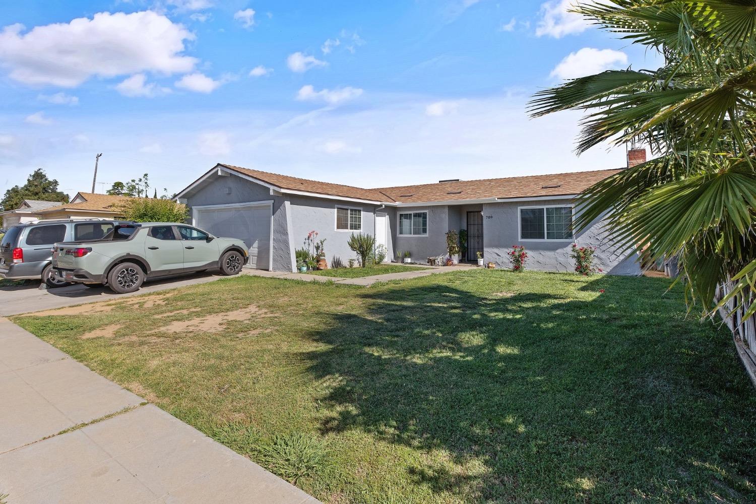 709 Ashlan Way Madera, CA 93638 - Photo 2 of 23 a front view of a house with garden