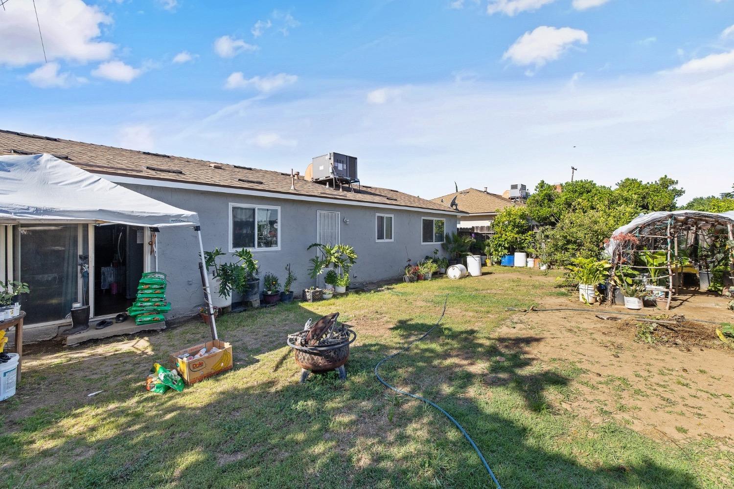 709 Ashlan Way Madera, CA 93638 - Photo 21 of 23 a view of a house with backyard porch and sitting area