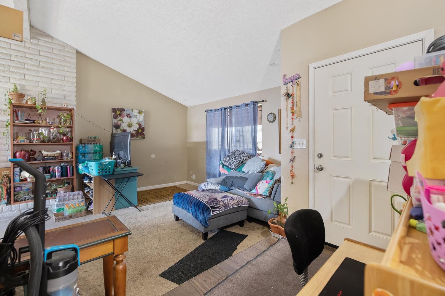 709 Ashlan Way Madera, CA 93638 - Photo 4 of 23 a bedroom with furniture and a book shelf