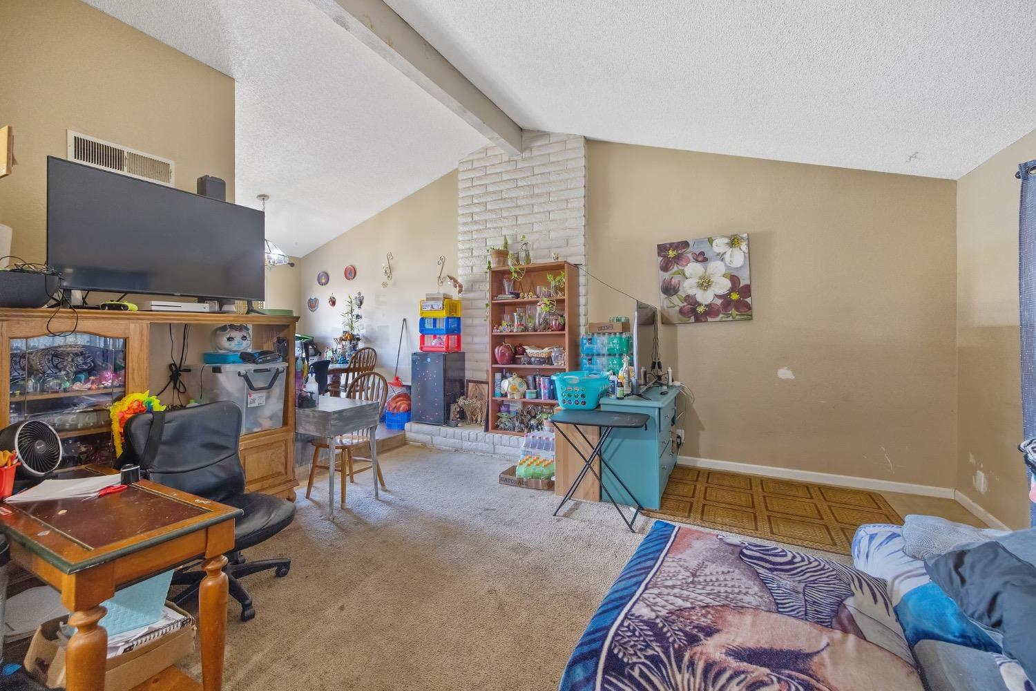 709 Ashlan Way Madera, CA 93638 - Photo 5 of 23 a bedroom with furniture and a flat screen tv