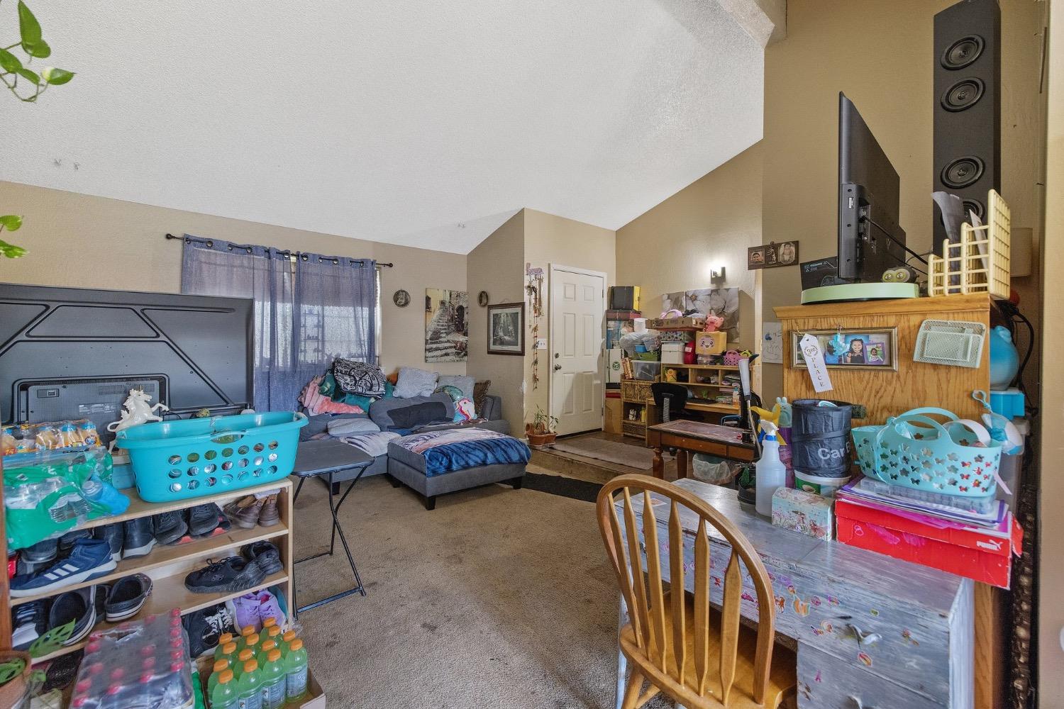 709 Ashlan Way Madera, CA 93638 - Photo 7 of 23 a living room filled with furniture and a baby crib