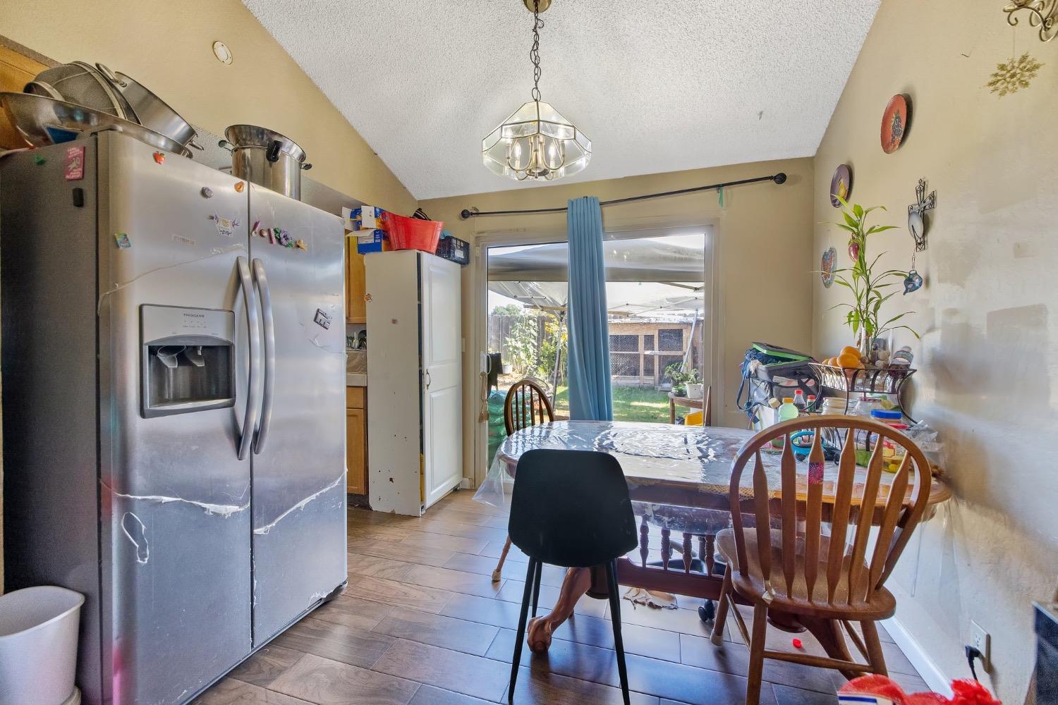 709 Ashlan Way Madera, CA 93638 - Photo 8 of 23 a view of a dining room with furniture window and wooden floor