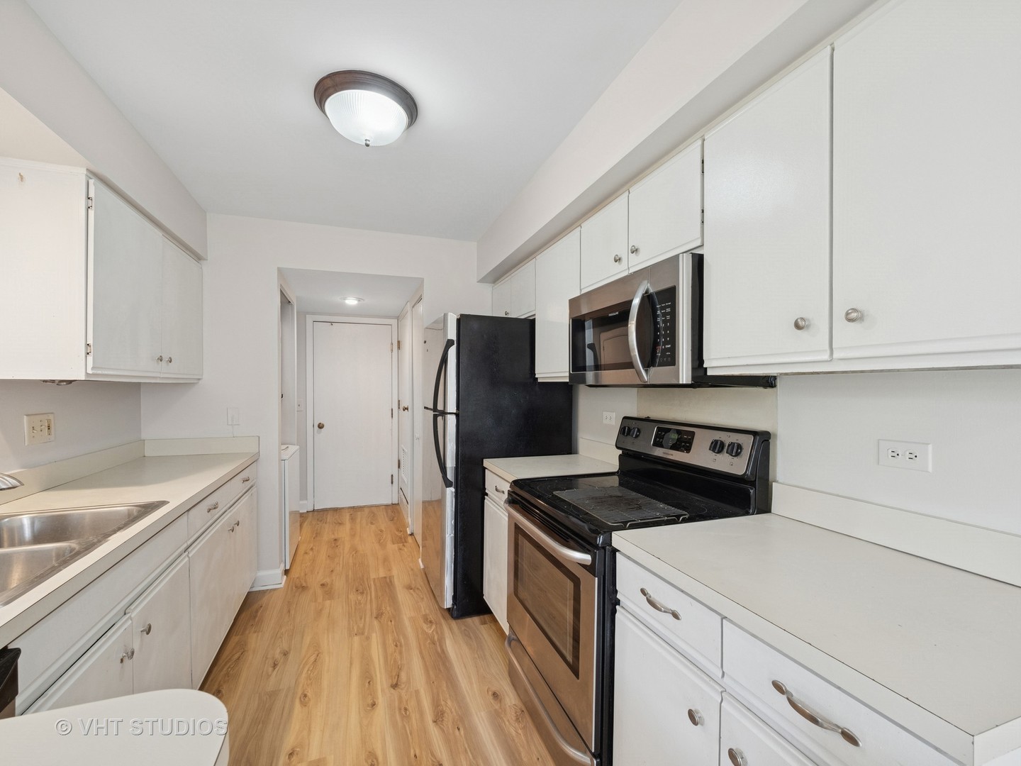 1102 North Knollwood Drive Palatine, IL 60067 - Photo 8 of 15 a kitchen with stainless steel appliances a stove a sink and a refrigerator