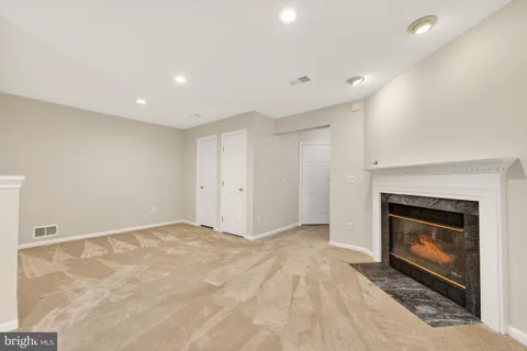 a view of empty room with a fireplace