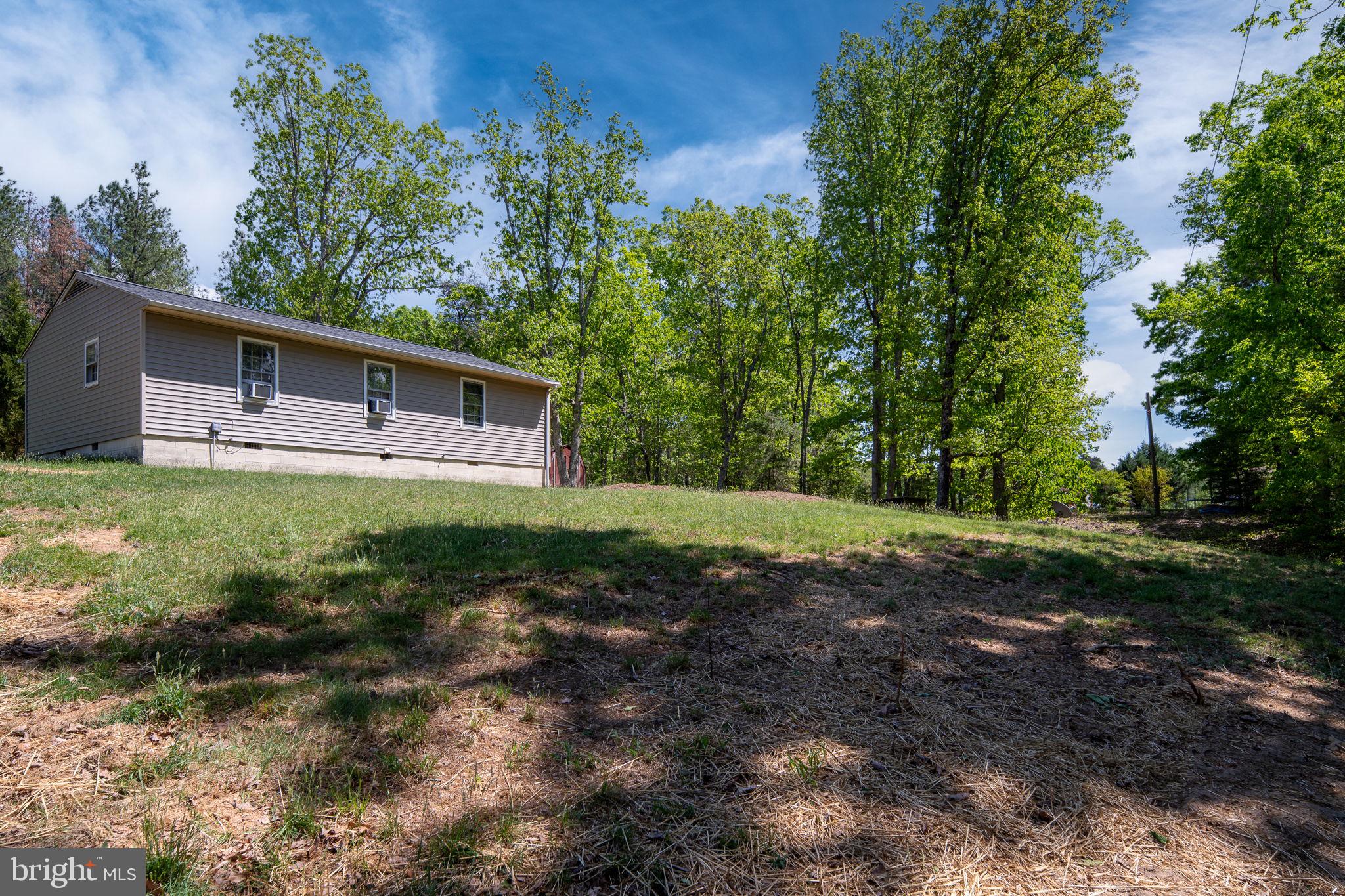 14208 Springfield Lane King George, VA 22485 - Photo 38 of 41 a backyard of a house with plants and large trees