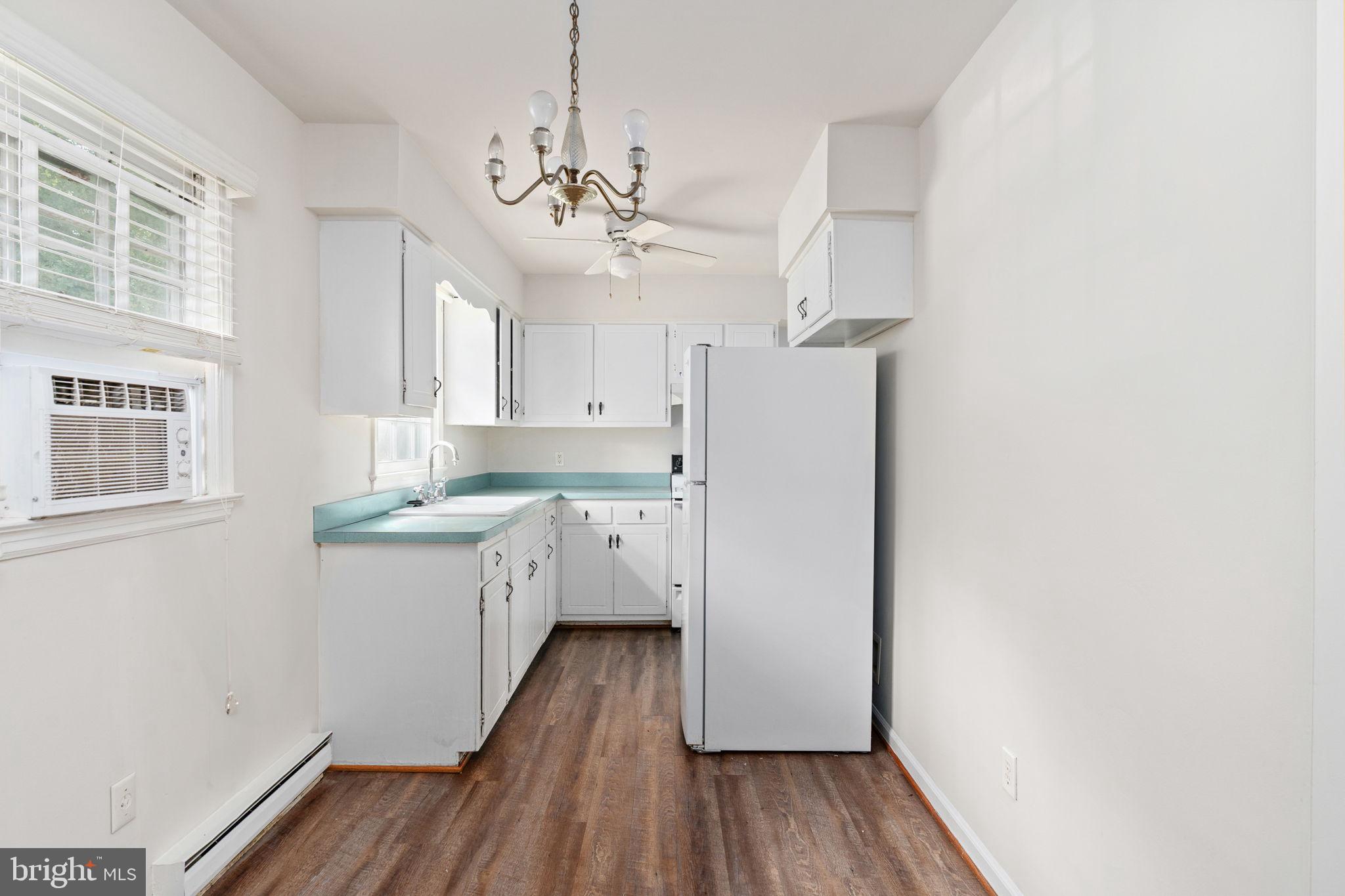 14208 Springfield Lane King George, VA 22485 - Photo 8 of 41 a kitchen with a refrigerator a sink and dishwasher with wooden floor