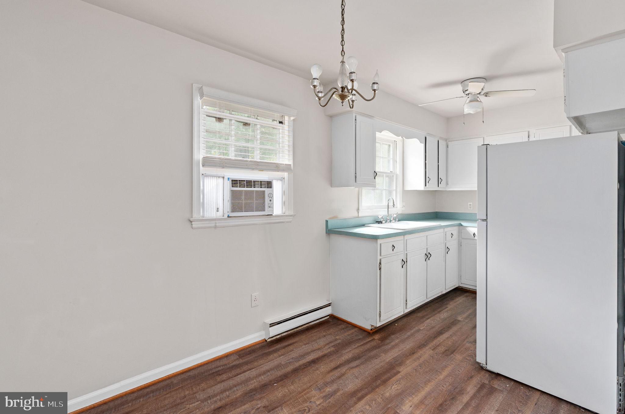 14208 Springfield Lane King George, VA 22485 - Photo 9 of 41 a kitchen with granite countertop white cabinets and window