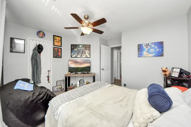 a bedroom with a bed and a chandelier