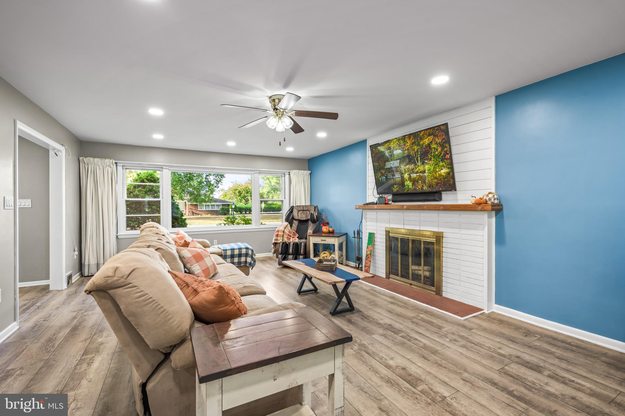 376 Griscom Drive Mannington, NJ 08079 - Photo 11 of 48 a living room with furniture a fireplace and a flat screen tv