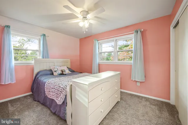 a bedroom with furniture and a large window