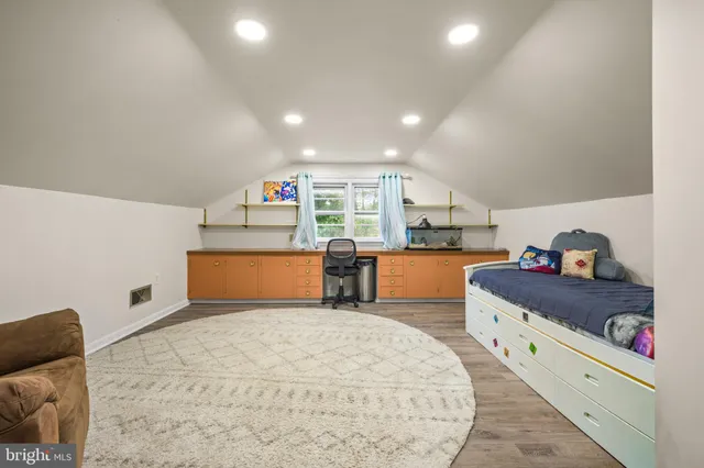 a view of a hallway with wooden floor and windows