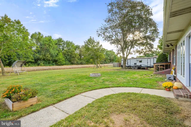 a view of a house with a yard and a tree