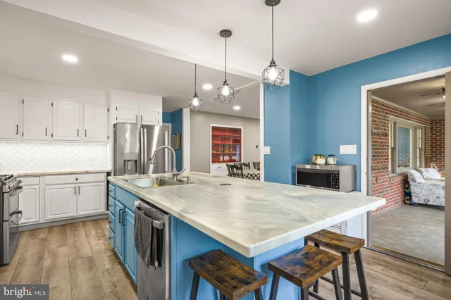 a kitchen with a sink a stove and refrigerator