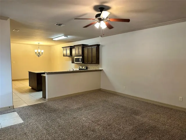 a view of a kitchen with a sink and a microwave