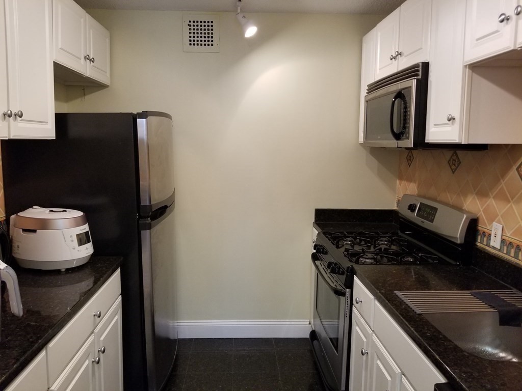 44 Washington Street, Unit 601 Brookline, MA 02445 - Photo 5 of 24 a kitchen with a sink stove and microwave