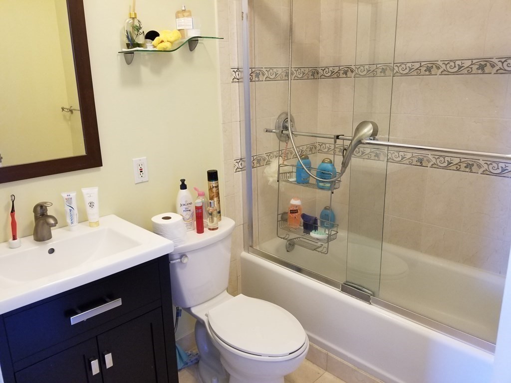 44 Washington Street, Unit 601 Brookline, MA 02445 - Photo 7 of 24 a bathroom with a sink mirror vanity and toilet