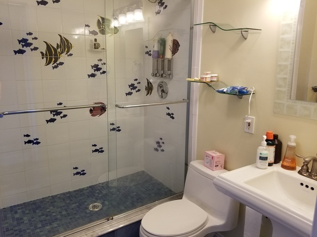 44 Washington Street, Unit 601 Brookline, MA 02445 - Photo 8 of 24 a bathroom with a sink toilet and shower