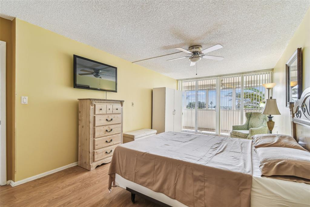 17920 Gulf Boulevard, Unit 208 Redington Shores, FL 33708 - Photo 30 of 98 a bedroom with a bed and a flat screen tv