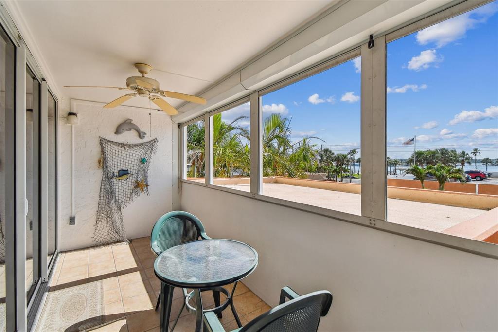 17920 Gulf Boulevard, Unit 208 Redington Shores, FL 33708 - Photo 41 of 98 a living room with furniture and a floor to ceiling window