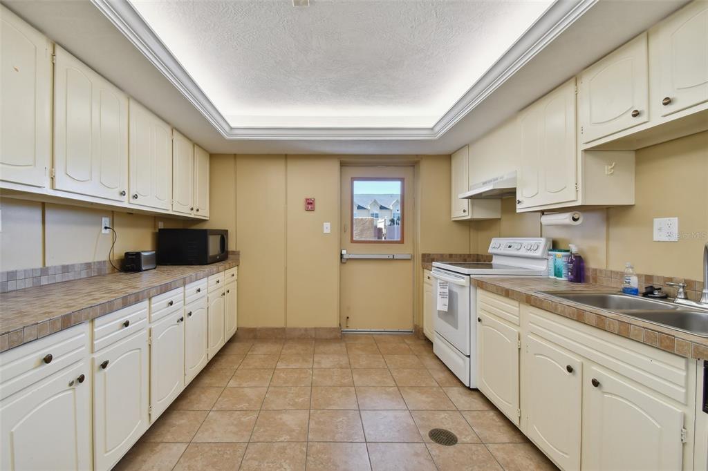 17920 Gulf Boulevard, Unit 208 Redington Shores, FL 33708 - Photo 79 of 98 a kitchen with cabinets appliances a sink and a counter top space