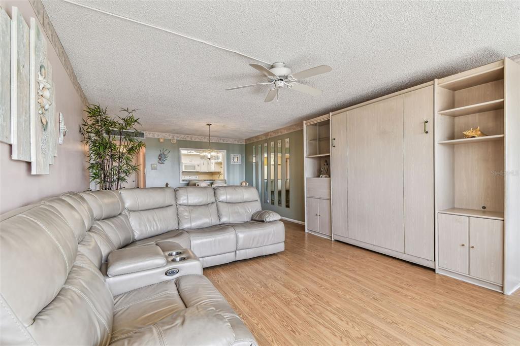 17920 Gulf Boulevard, Unit 208 Redington Shores, FL 33708 - Photo 8 of 98 a living room with furniture and a chandelier