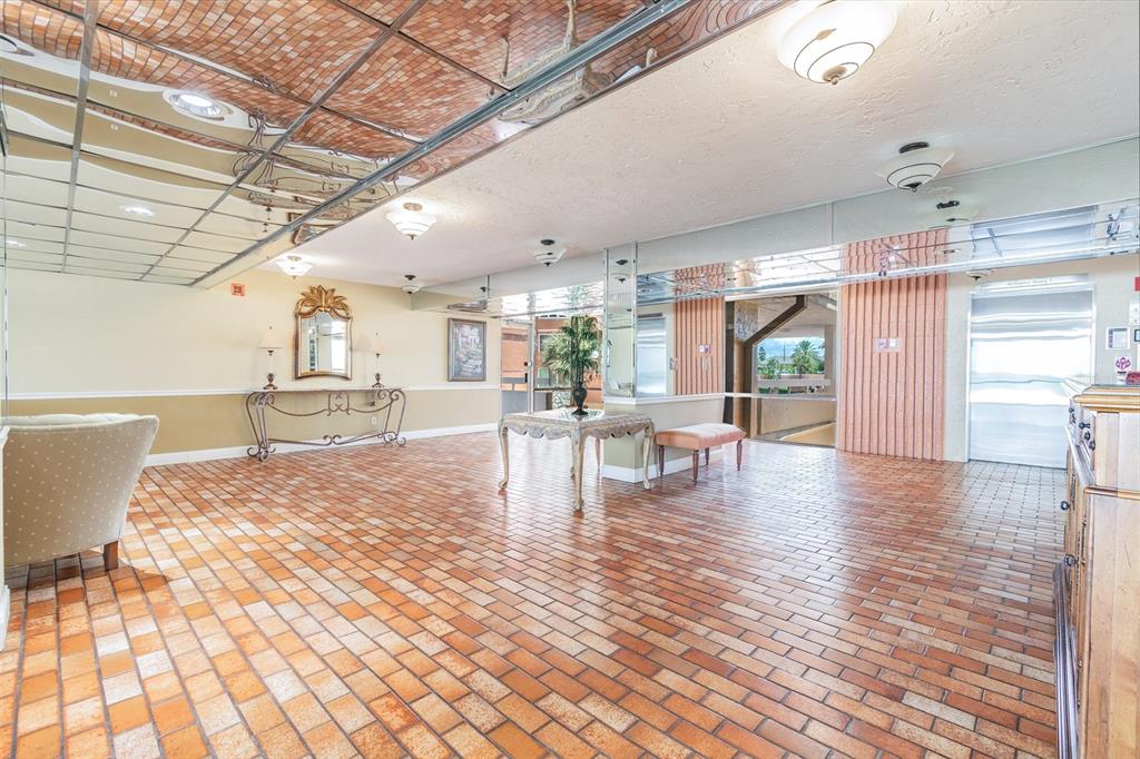 17920 Gulf Boulevard, Unit 208 Redington Shores, FL 33708 - Photo 84 of 98 a view of a dining room and livingroom with furniture wooden floor a chandelier